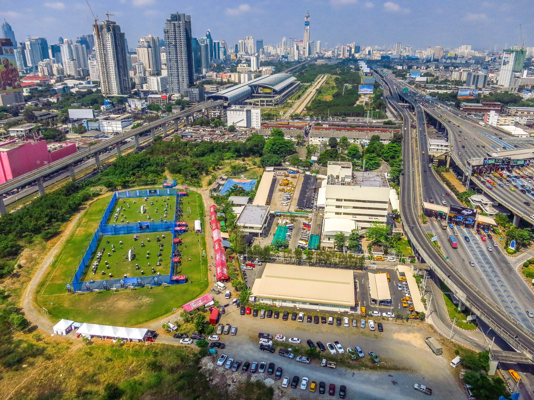 Aerial view of a Bangkok event site beside elevated railways and highways