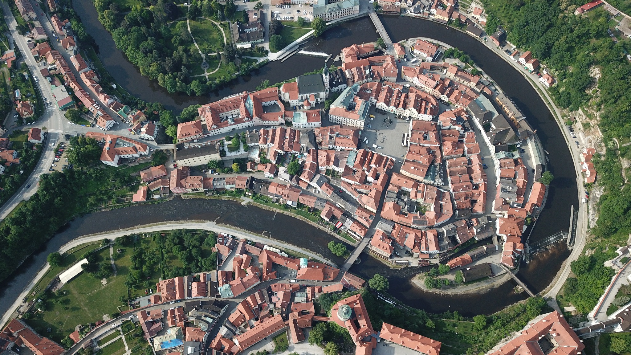 Top-down aerial view of Český Krumlov surrounded by the winding Vltava River