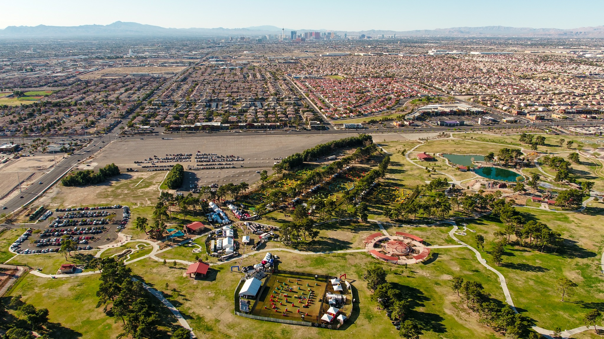 High aerial overview of an outdoor sporting event, park and Las Vegas skyline