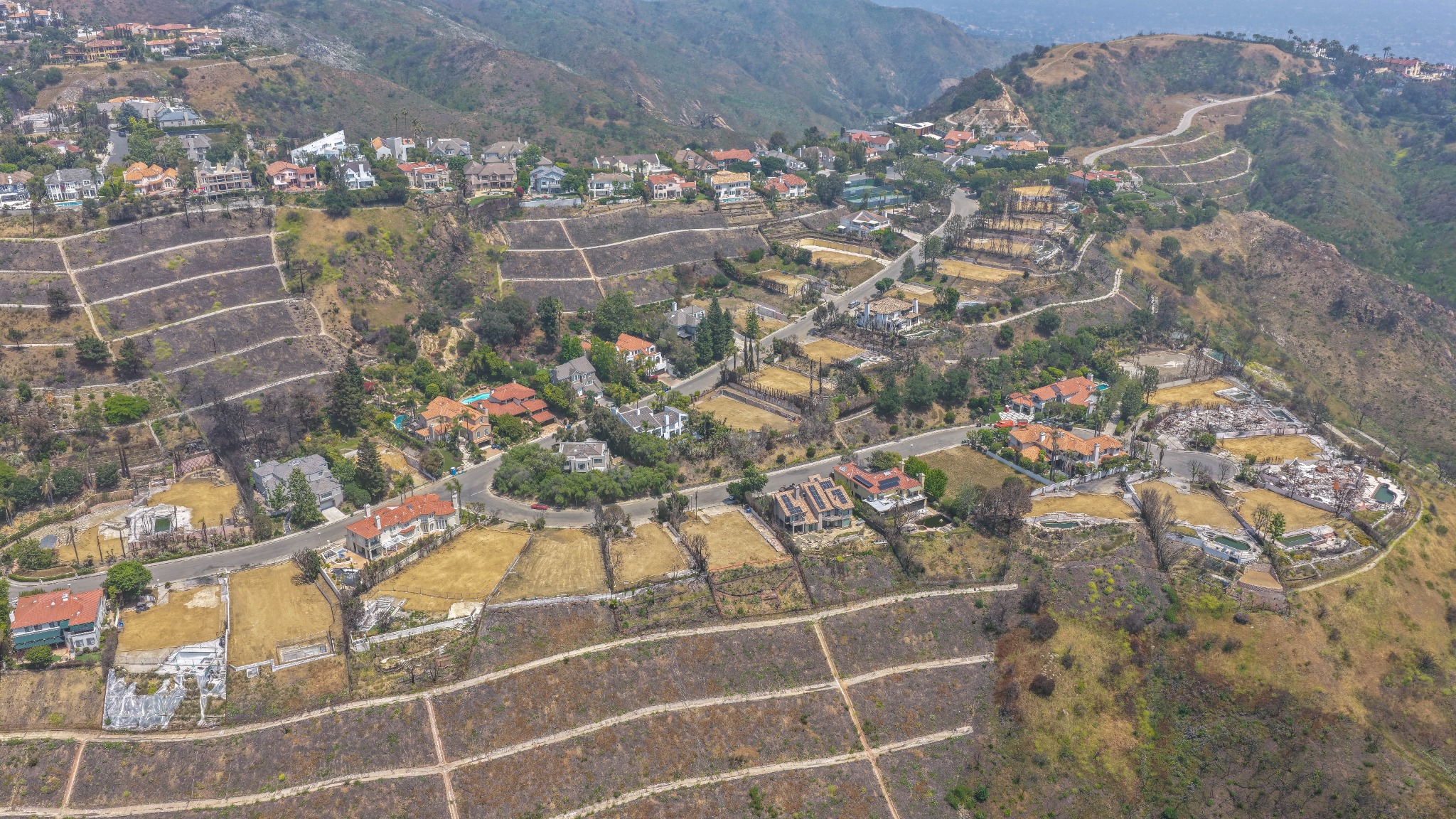 Aerial documentation of homes and fire-damaged lots in the Pacific Palisades hills