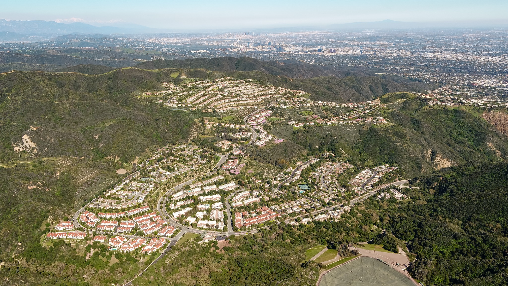 High aerial view of the Palisades Highlands with Los Angeles stretching into the distance