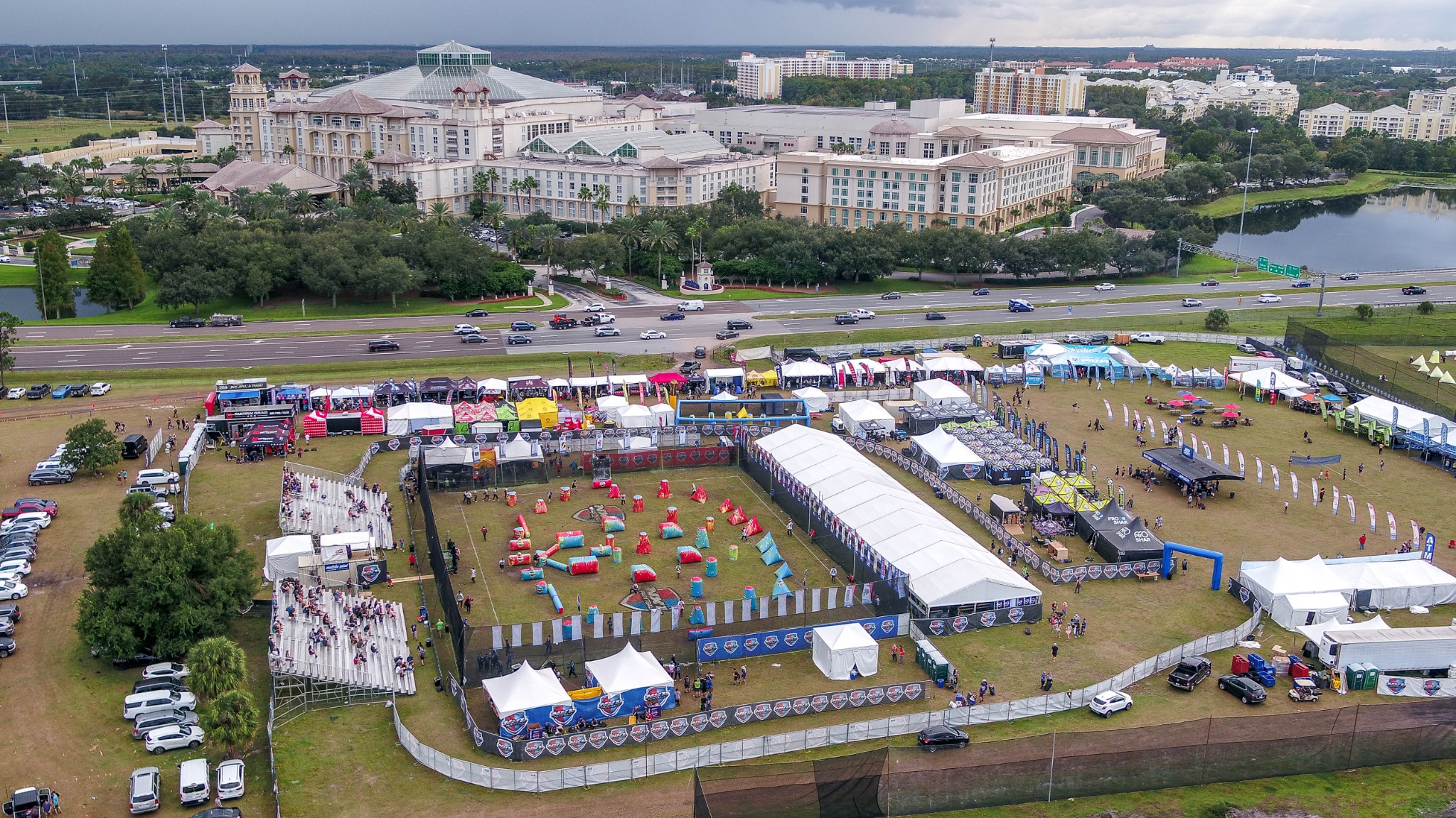 Aerial view of a paintball event beside a resort and divided highway